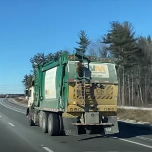 高速道路を走行中に出くわしたまさかの光景。目の前を走るゴミ収集車の後ろにはしがみつくアライグマの姿が！【米・動画】